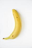 Ripe yellow banana on a white background. A bunch of fresh bananas. Sweet bananas for breakfast. photo