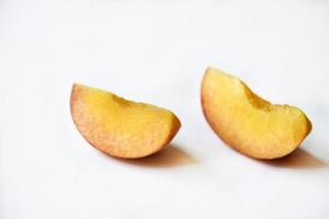 Sliced fresh peaches on a white background. photo