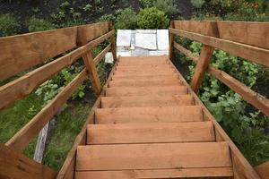 View down the flight of wooden stairs in summer photo