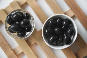 Black delicious fresh olives in a saucepan photo