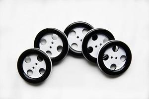 Large black and white buttons with clothes on a white background photo