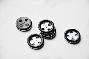 Large black and white buttons with clothes on a white background photo