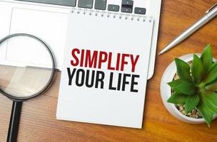 Simplify Your Life writing text post it paper in office on laptop computer keyboard photo