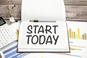 start today sign on notepad on the white background photo