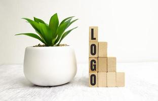 Logo written on a wooden cube in a office desk photo