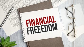 financial freedom text concept on note paper photo