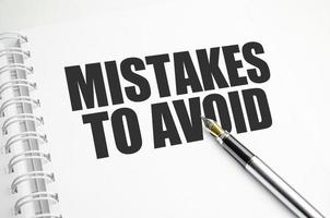 Mistakes word message on white paper book and copy space on white desk photo