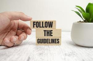 with FOLLOW THE GUIDELINES Concepts on wooden blocks photo