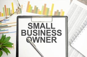 small business owner . text on notepad on wood table photo