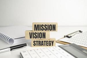 with MISSION, VISION, strategy Concepts on wooden blocks photo