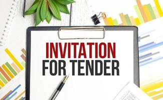 Text INVITATION FOR TENDER concept on wooden background photo