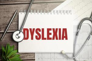 Paper with dyslexia on a table and grey stethoscope photo