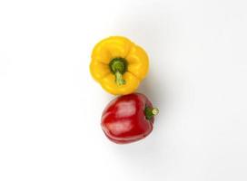 Red and yellow bell peppers isolated on white background. organic fruits for healthy meal cooking photo