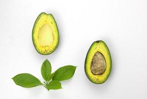 Avocado sliced and leaves on white background. Two pieces of avocado with leaves for Food concepts design, Top view