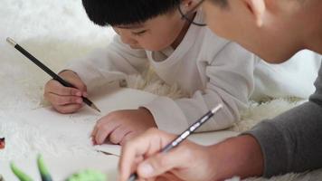 Father teaching son homework enjoy at home together. video