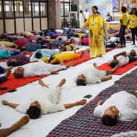 New Delhi, India, June 19 2022 -Group Yoga exercise session for people of different age groups in Balaji Temple, Vivek Vihar, International Yoga Day, Big group of adults attending yoga class in temple photo