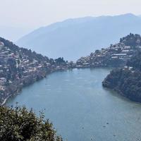 Full view of Naini Lake during evening time near Mall Road in Nainital, Uttarakhand, India, Beautiful view of Nainital Lake with mountains and blue sky photo