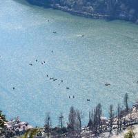 Full view of Naini Lake during evening time near Mall Road in Nainital, Uttarakhand, India, Beautiful view of Nainital Lake with mountains and blue sky photo