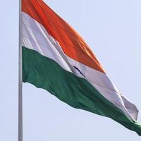 India flag flying high at Connaught Place with pride in blue sky, India flag fluttering, Indian Flag on Independence Day and Republic Day of India, tilt up shot, waving Indian flag, Flying India flags photo