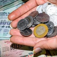 Rare Old Indian bank rupee coins falling on currency notes, Falling down Indian rupee coin on one hundred rupees notes, Indian Currency Coins falling photo