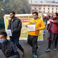 New Delhi, India December 25 2021 - Delhi Contractual Guest Teachers with posters, flags and graffitis protesting against Delhi AAP Government for making policy, Delhi Guest Teachers protesting photo