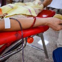 Blood donor at Blood donation camp held with a bouncy ball holding in hand at Balaji Temple, Vivek Vihar, Delhi, India, Image for World blood donor day on June 14 every year, Blood Donation Camp photo