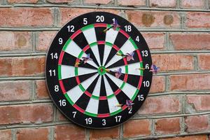 dart in bullseye on the target with many other Darts photo