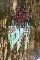 Handmade dream catcher with feathers threads and beads rope hanging photo