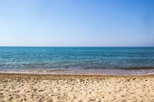 Seascape of sand shore and waves of Black sea photo