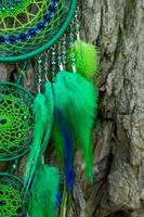 Handmade dream catcher with feathers threads and beads rope hanging photo