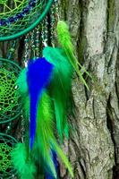 Handmade dream catcher with feathers threads and beads rope hanging photo