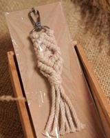 Macrame keychain, Macrame shot, handmade by women at home. Great DIY images for macrame and crafts banners and advertisements. creative hobby layout with accessories, top view. Handcrafted macrame. photo