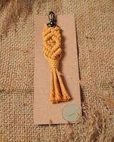 Macrame keychain, Macrame shot, handmade by women at home. Great DIY images for macrame and crafts banners and advertisements. creative hobby layout with accessories, top view. Handcrafted macrame. photo