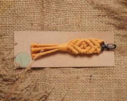 Macrame keychain, Macrame shot, handmade by women at home. Great DIY images for macrame and crafts banners and advertisements. creative hobby layout with accessories, top view. Handcrafted macrame. photo