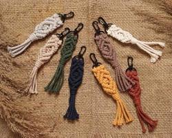 Macrame keychain, Macrame shot, handmade by women at home. Great DIY images for macrame and crafts banners and advertisements. creative hobby layout with accessories, top view. Handcrafted macrame. photo