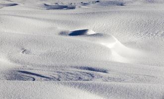 Deep snowdrifts   a winter frosty morning. On the ground lay snowdrifts after a night of snow photo