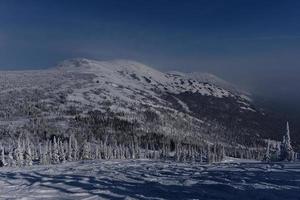 sunny winter morning in the mountains of sheregesh on the ski track photo