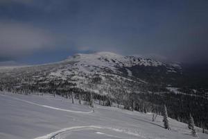 sunny winter morning in the mountains of sheregesh on the ski track photo