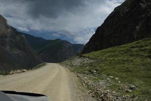 ribbon of the road among the slopes of the mountains on the expanses of Altai on a summer day photo