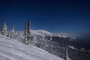 sunny winter morning in the mountains of sheregesh on the ski track photo