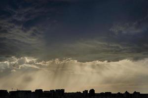 boundless expanse of the sky with cumulus clouds and rays of the sun, moments of daybreak and sunset photo