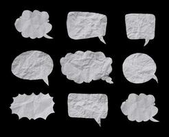 White crumpled paper texture in bubble speech shape. Set of balloon text isolated in black background.
