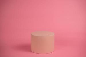 Empty podium for display cosmetic product. Platform arrangement in pink pastel color in trendy minimalist style. Composition of cylinders and cubes layout for feminine background photo