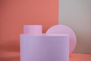 Empty podium for display cosmetic product. Platform arrangement in pink pastel color in trendy minimalist style. Composition of cylinders and cubes layout for feminine background photo