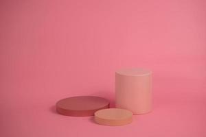 Empty podium for display cosmetic product. Platform arrangement in pink pastel color in trendy minimalist style. Composition of cylinders and cubes layout for feminine background photo