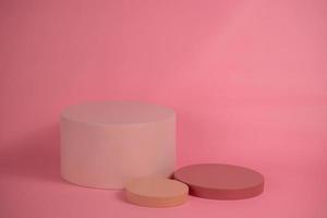 Empty podium for display cosmetic product. Platform arrangement in pink pastel color in trendy minimalist style. Composition of cylinders and cubes layout for feminine background photo