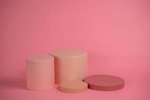 Empty podium for display cosmetic product. Platform arrangement in pink pastel color in trendy minimalist style. Composition of cylinders and cubes layout for feminine background photo