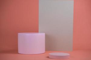 Empty podium for display cosmetic product. Platform arrangement in pink pastel color in trendy minimalist style. Composition of cylinders and cubes layout for feminine background photo