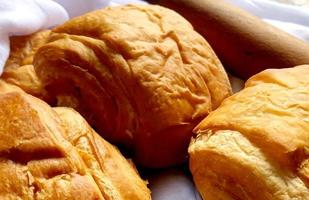 Fresh patty pieces placed next to a wooden rolling pin to spread the pastries photo