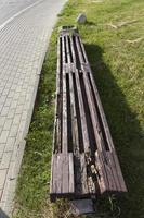 an old rotting wooden bench in the park photo